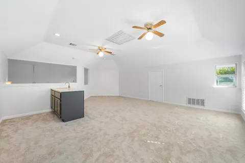 an aerial view of a house with a yard basket ball court and outdoor seating