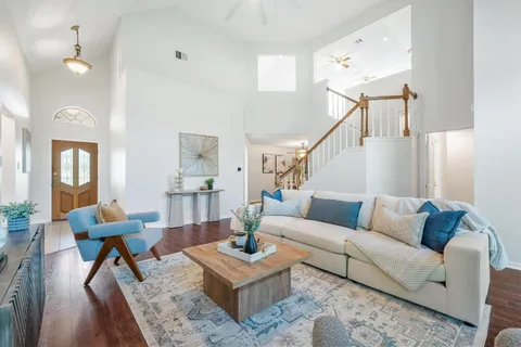 a living room with furniture fireplace and wooden floor