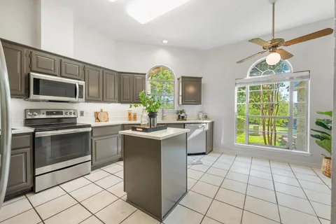 a kitchen with a sink and refrigerator