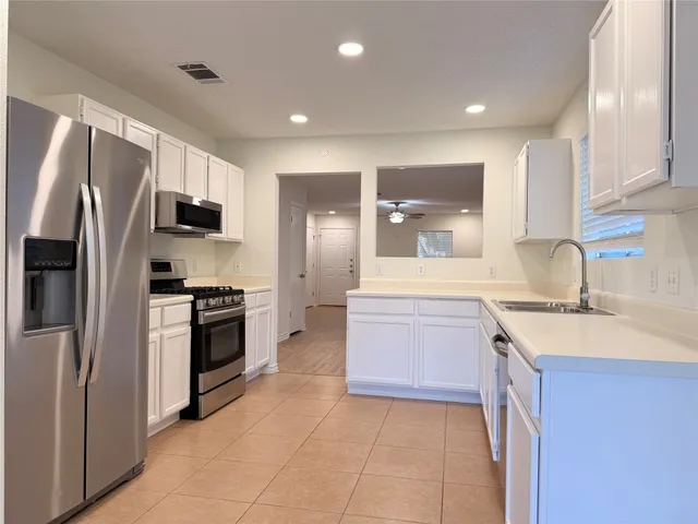 a kitchen with a sink stove and refrigerator
