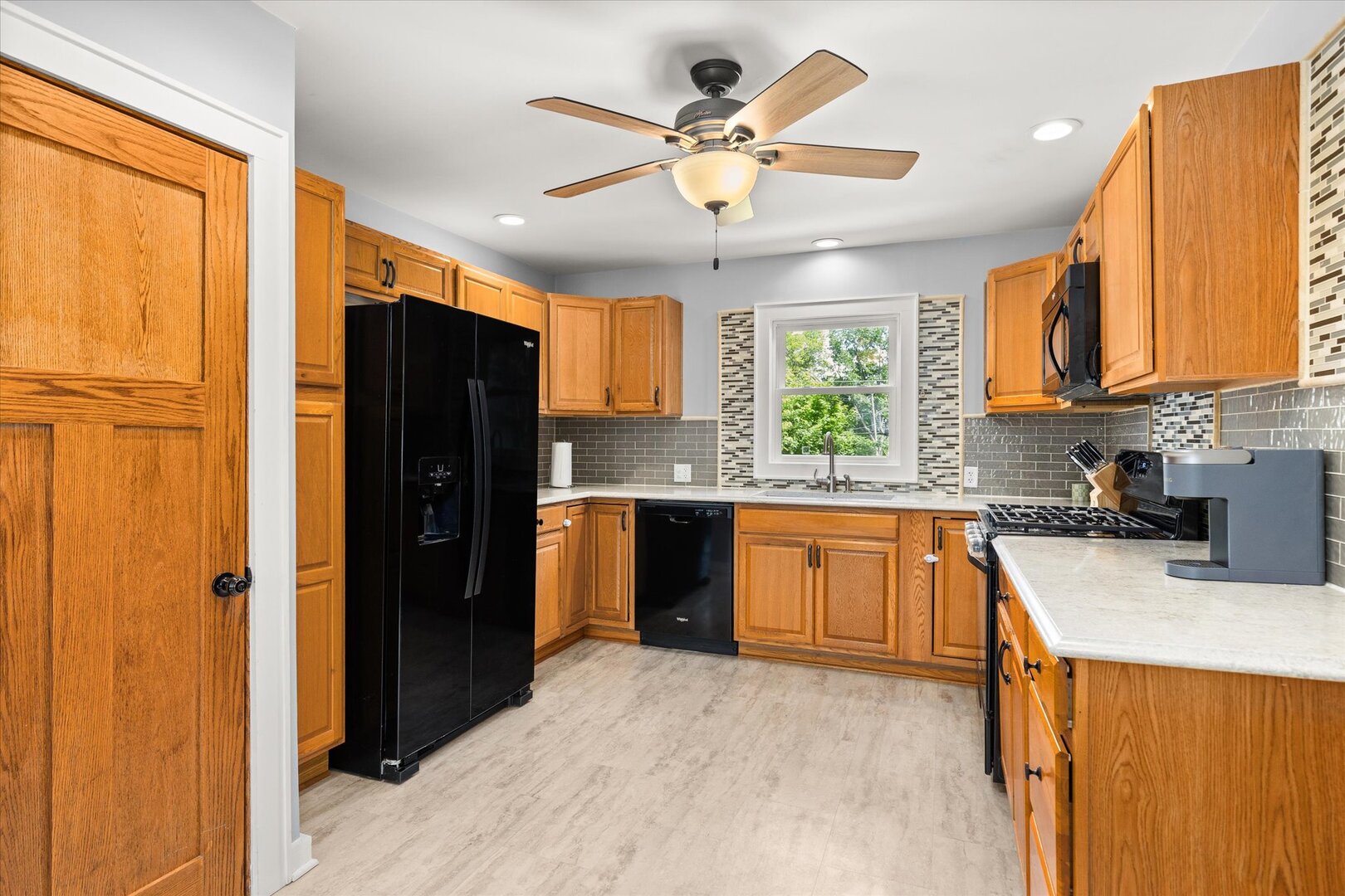 742 Chambers Street Ottawa, IL 61350 - Photo 15 of 39 a kitchen with stainless steel appliances granite countertop a refrigerator a sink dishwasher a stove and a dining table with wooden cabinet