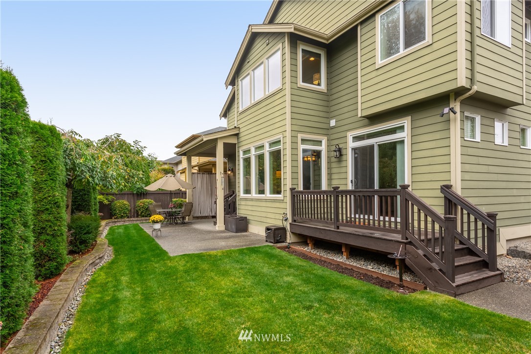 6785 Southeast 2nd Street Renton, WA 98059 - Photo 22 of 23 a view of a house with a backyard and wooden deck