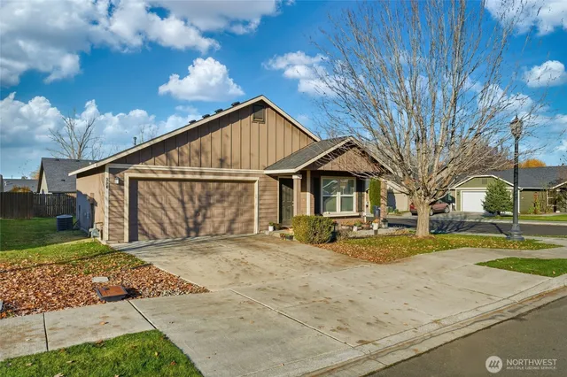 a view of house with yard and sitting area