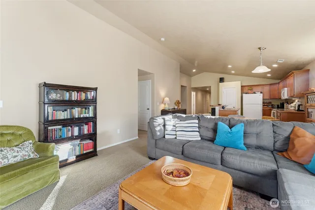 a living room with furniture and a shelf