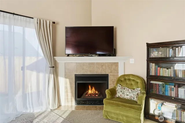 a living room with fireplace furniture and a flat screen tv