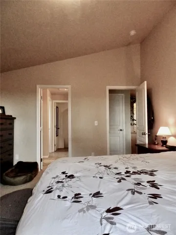 a bedroom with a bed and a mirror