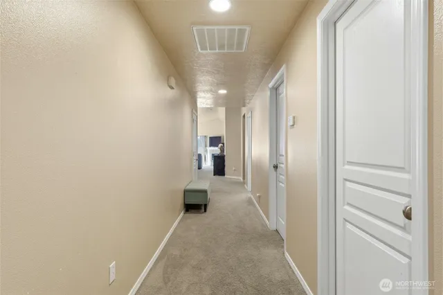 a view of a hallway with white walls