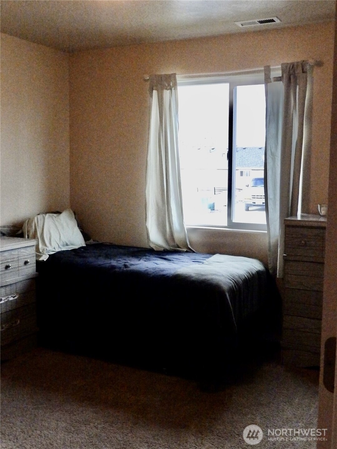 304 Southwest Homestead Avenue College Place, WA 99324 - Photo 7 of 21 a bedroom with a bed next to a window