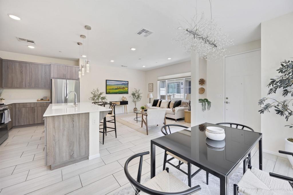 35103 Vine Place Fallbrook, CA 92028 - Photo 12 of 42 a living room with furniture and a dining table with kitchen view