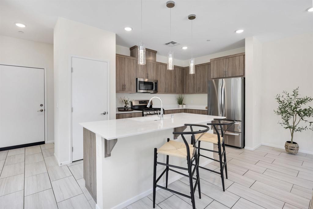 35103 Vine Place Fallbrook, CA 92028 - Photo 14 of 42 a kitchen with stainless steel appliances a refrigerator and a stove top oven