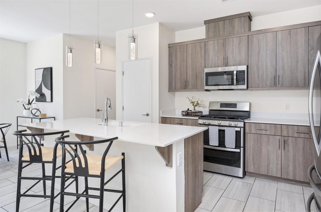 35103 Vine Place Fallbrook, CA 92028 - Photo 15 of 42 a kitchen with stainless steel appliances a stove a sink island and a refrigerator
