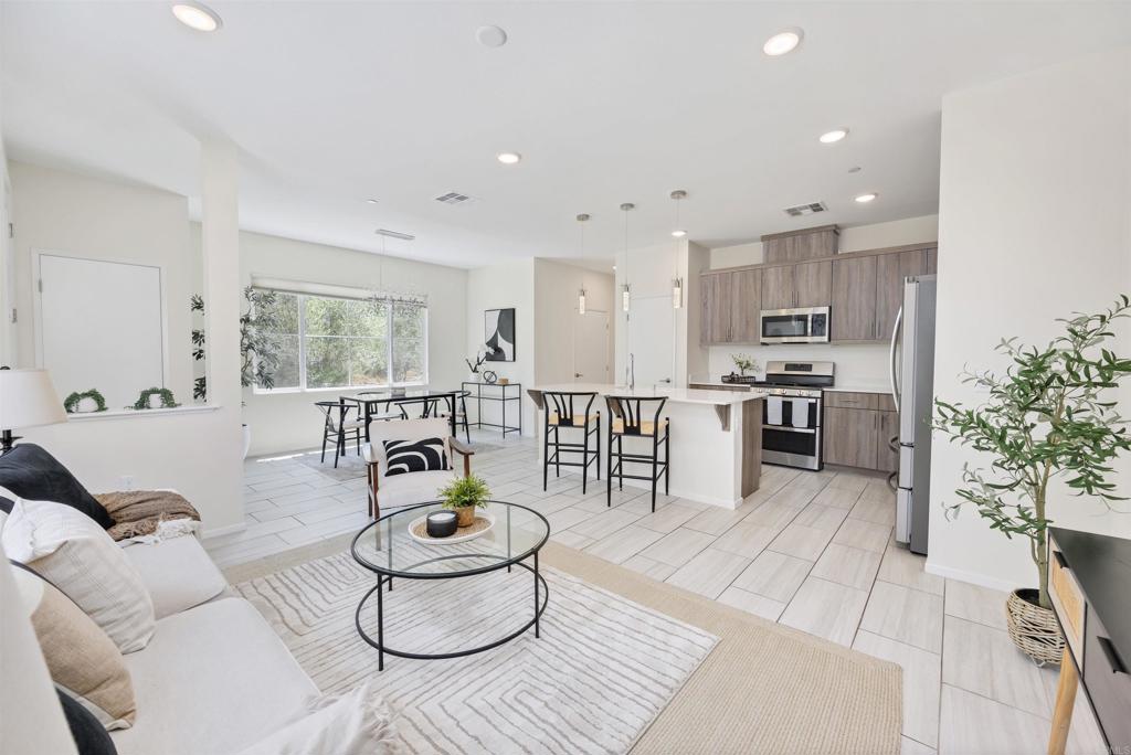 35103 Vine Place Fallbrook, CA 92028 - Photo 16 of 42 a living room with stainless steel appliances furniture a rug and a kitchen view