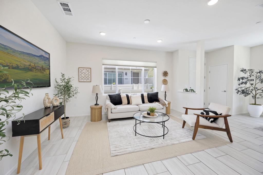 35103 Vine Place Fallbrook, CA 92028 - Photo 18 of 42 a living room with furniture a flat screen tv and a window