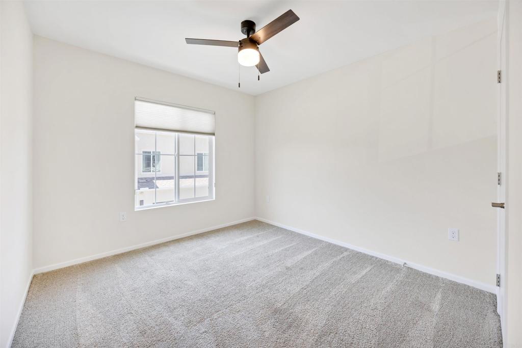 35103 Vine Place Fallbrook, CA 92028 - Photo 29 of 42 an empty room with windows and fan