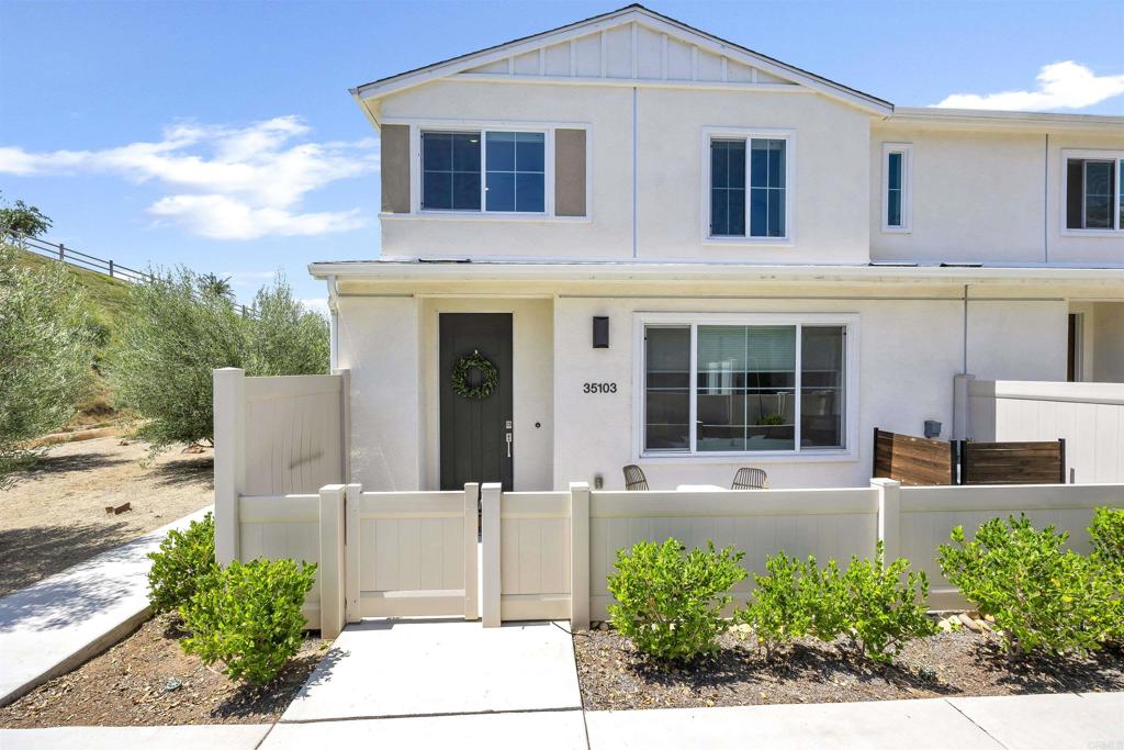 35103 Vine Place Fallbrook, CA 92028 - Photo 3 of 42 a front view of a house with a garden