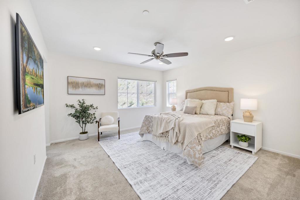 35103 Vine Place Fallbrook, CA 92028 - Photo 31 of 42 a bedroom with a large bed and a chandelier