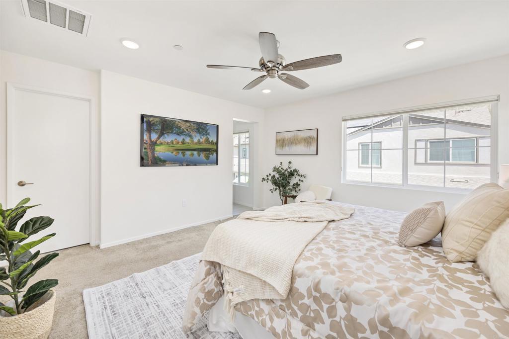 35103 Vine Place Fallbrook, CA 92028 - Photo 32 of 42 a bedroom with a large bed and a chandelier