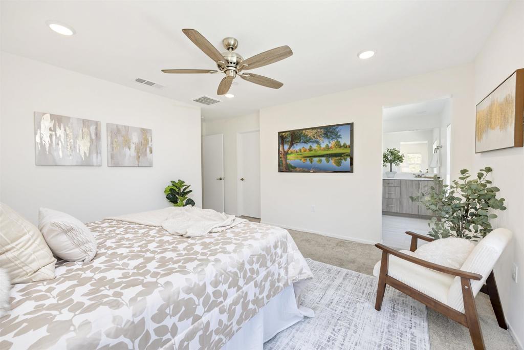 35103 Vine Place Fallbrook, CA 92028 - Photo 33 of 42 a bedroom with a bed and a potted plant