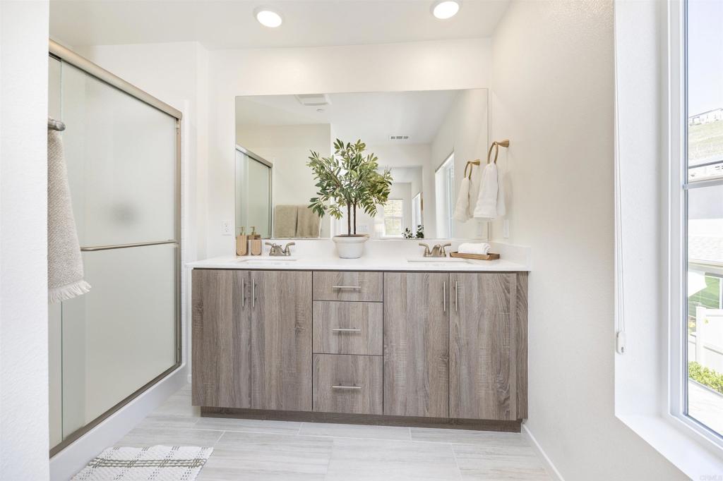 35103 Vine Place Fallbrook, CA 92028 - Photo 35 of 42 a bathroom with a double vanity sink and a mirror