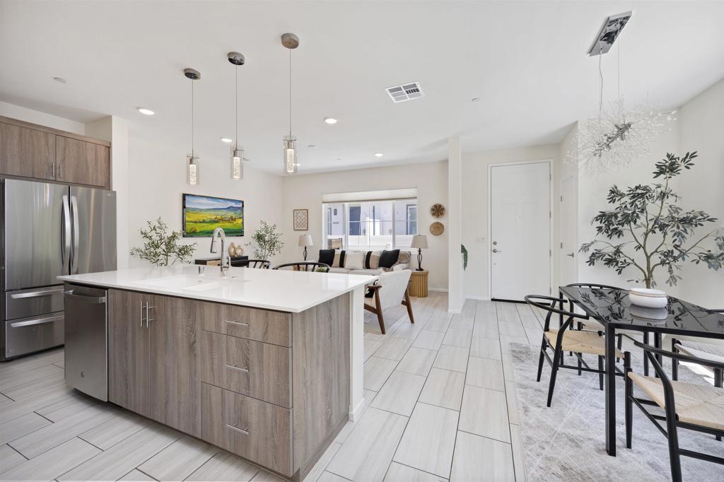 35103 Vine Place Fallbrook, CA 92028 - Photo 10 of 42 a kitchen with stainless steel appliances kitchen island granite countertop a table chairs and a refrigerator