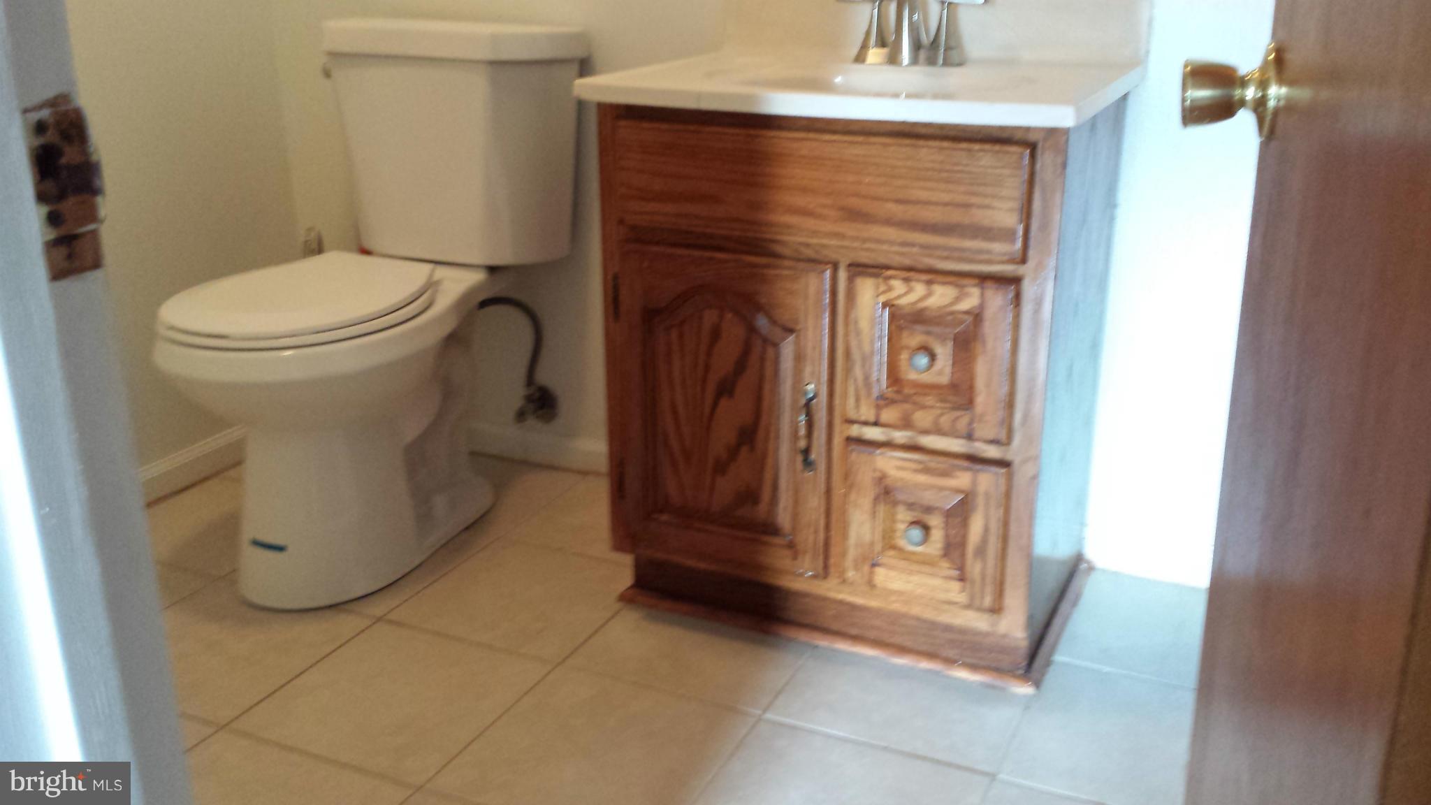 5503 Whitfield Chapel Road Lanham, MD 20706 - Photo 22 of 30 a bathroom with a toilet and a vanity