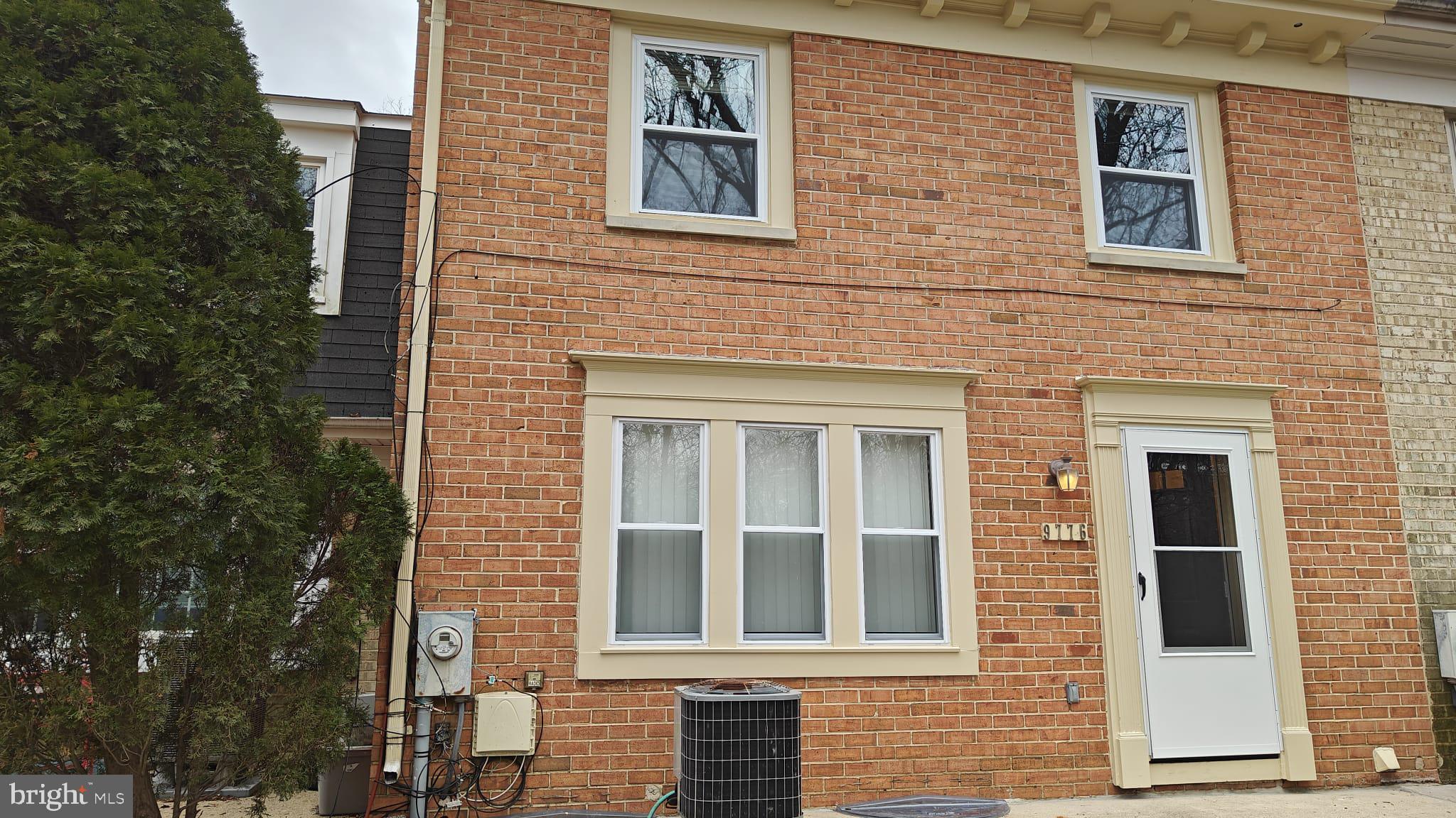a view of a brick house with a large windows