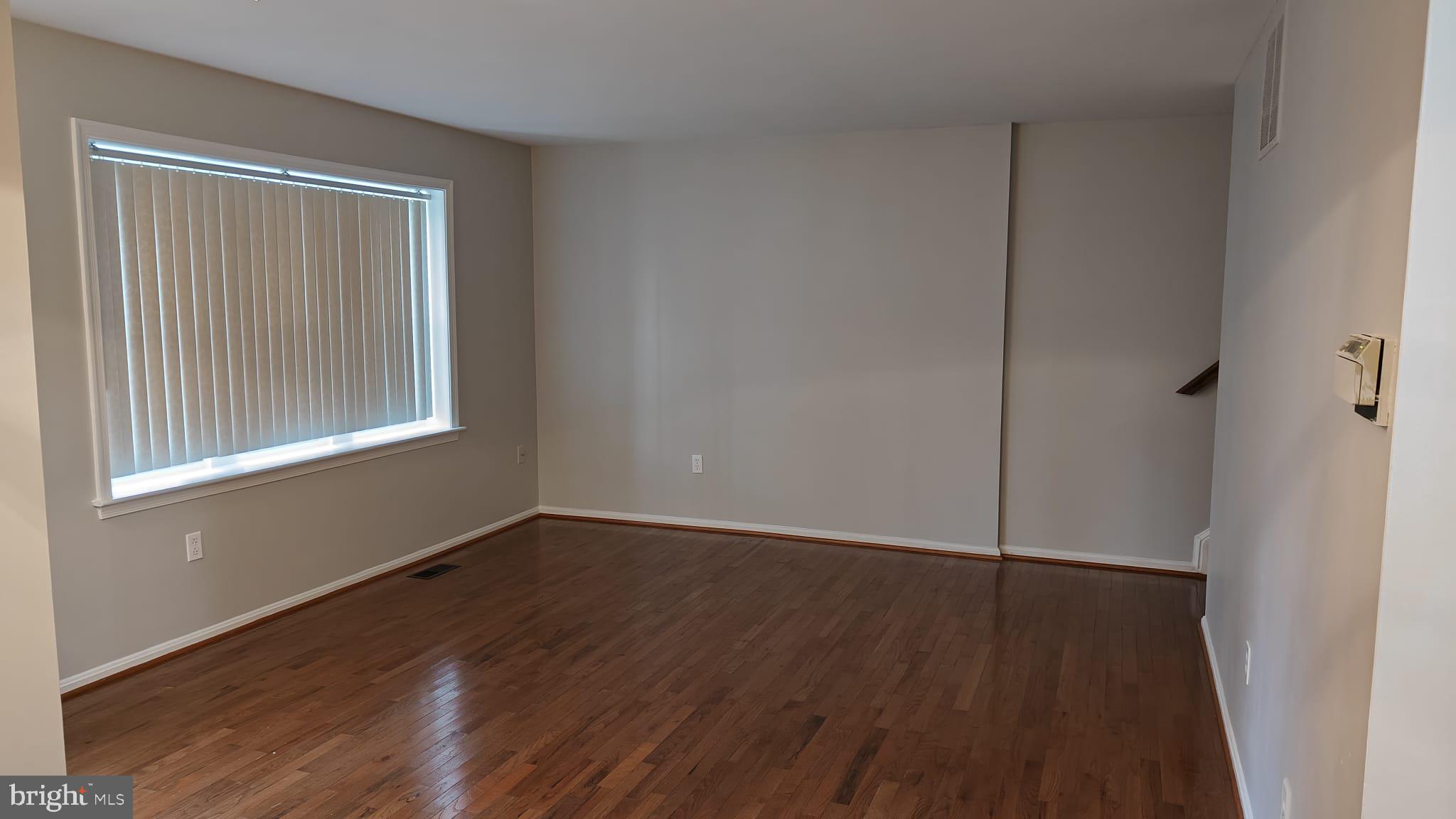 9776 Whiskey Run Laurel, MD 20723 - Photo 11 of 23 a view of an empty room with wooden floor and a window