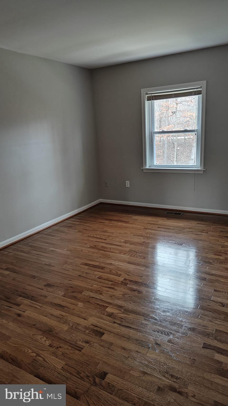 9776 Whiskey Run Laurel, MD 20723 - Photo 13 of 23 a view of an empty room with wooden floor and a window