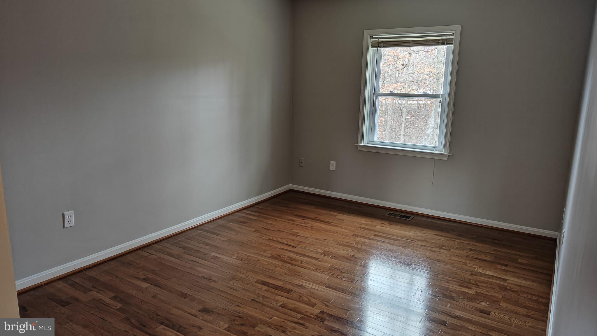 9776 Whiskey Run Laurel, MD 20723 - Photo 4 of 23 an empty room with wooden floor and windows