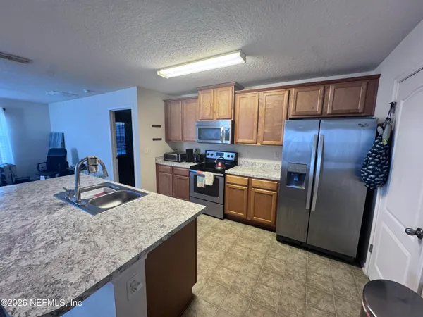 a kitchen with granite countertop counter top space cabinets and stainless steel appliances