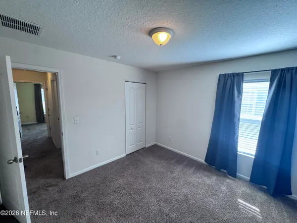 an empty room with window and entrance