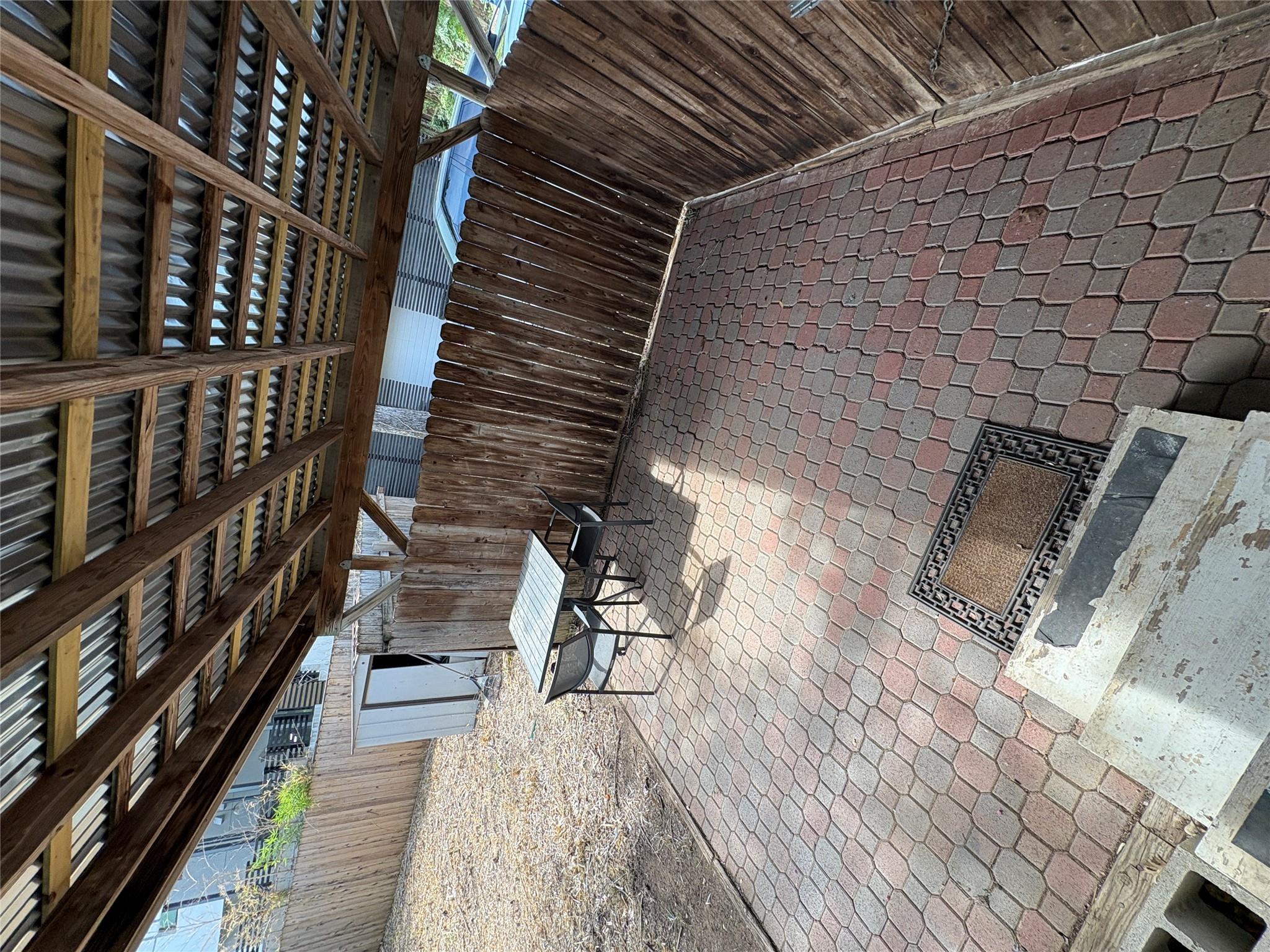 915 West 29th Street Austin, TX 78705 - Photo 19 of 20 Covered patio featuring a corrugated metal roof and exposed wood beams