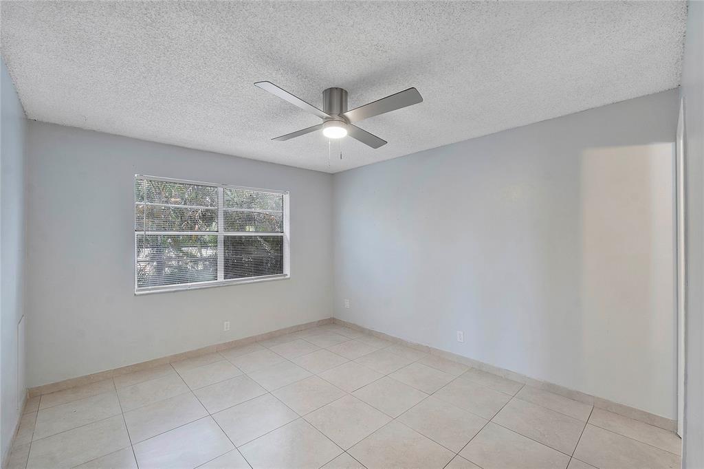 395 Southwest 15th Street, Unit 10 Pompano Beach, FL 33060 - Photo 11 of 14 a view of an empty room with a window