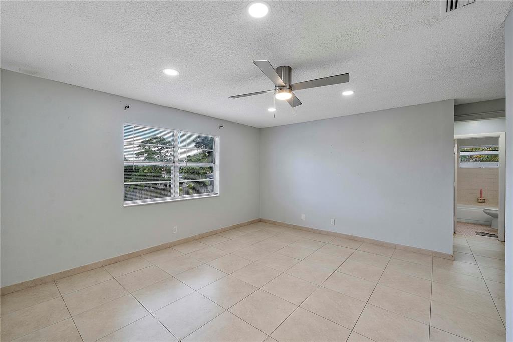 395 Southwest 15th Street, Unit 10 Pompano Beach, FL 33060 - Photo 14 of 14 a view of an empty room with a window