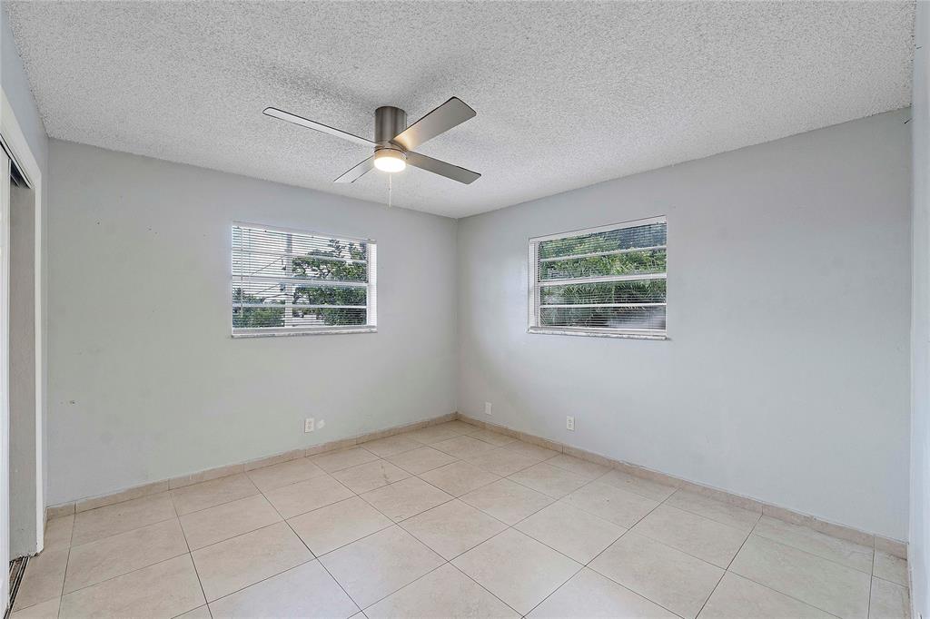 395 Southwest 15th Street, Unit 10 Pompano Beach, FL 33060 - Photo 5 of 14 a view of an empty room with a window