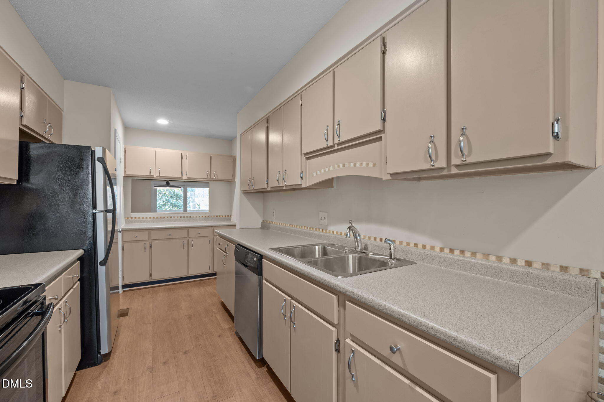206 Ridge Trail Chapel Hill, NC 27516 - Photo 5 of 32 a kitchen with a sink dishwasher a refrigerator and cabinets