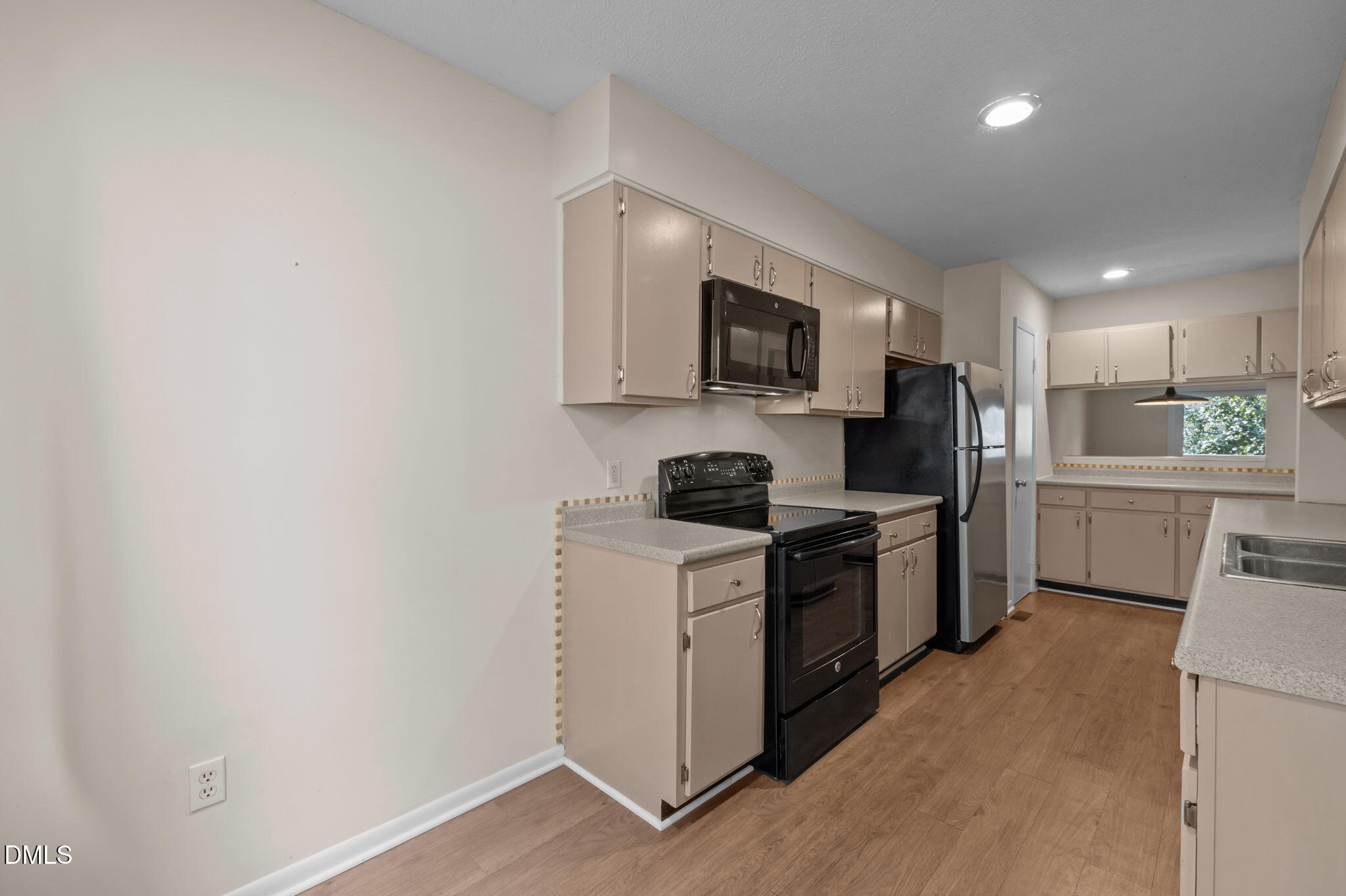 206 Ridge Trail Chapel Hill, NC 27516 - Photo 7 of 32 a kitchen with a sink a stove top oven and white stainless steel appliances