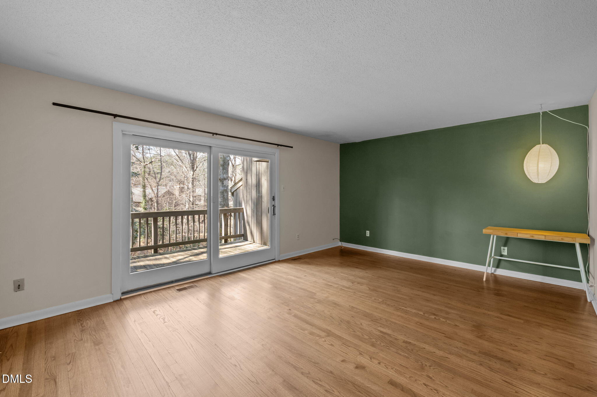 206 Ridge Trail Chapel Hill, NC 27516 - Photo 9 of 32 a view of an empty room with a window and wooden floor