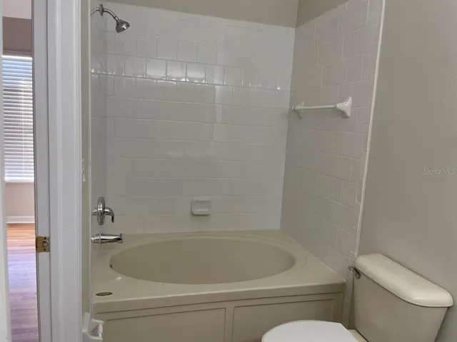a bathroom with a bathtub and toilet