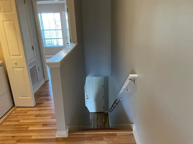 a view of entryway and hall with wooden floor