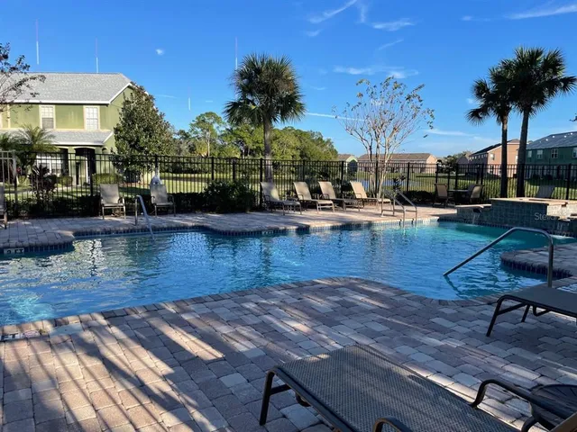 a view of a swimming pool with a table and chairs