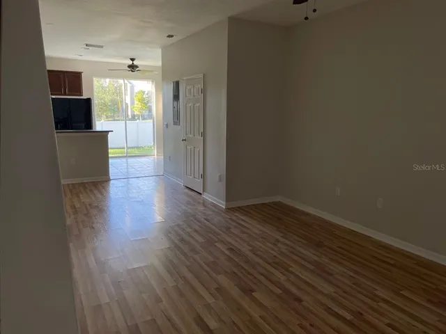 a view of a room with wooden floor and a cabinet