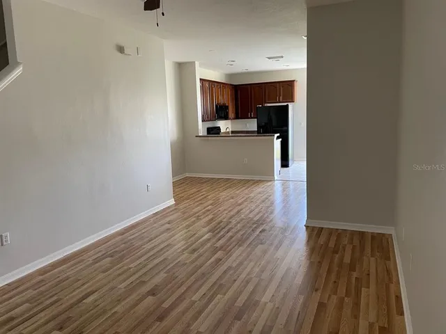 a view of a kitchen with wooden floor and a sink