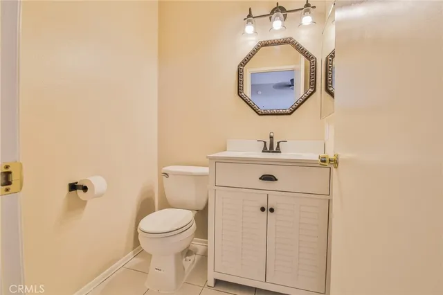 a bathroom with a sink mirror and toilet