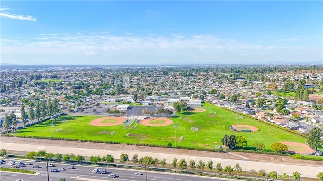 an aerial view of a swimming pool with outdoor seating