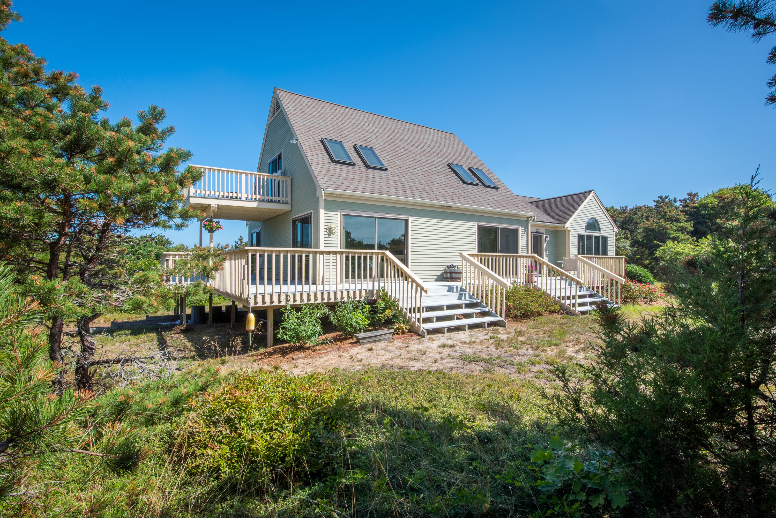 11 Pilgrim Pond Road Truro, MA 02666 - Photo 1 of 35 a view of a house with a yard and sitting area