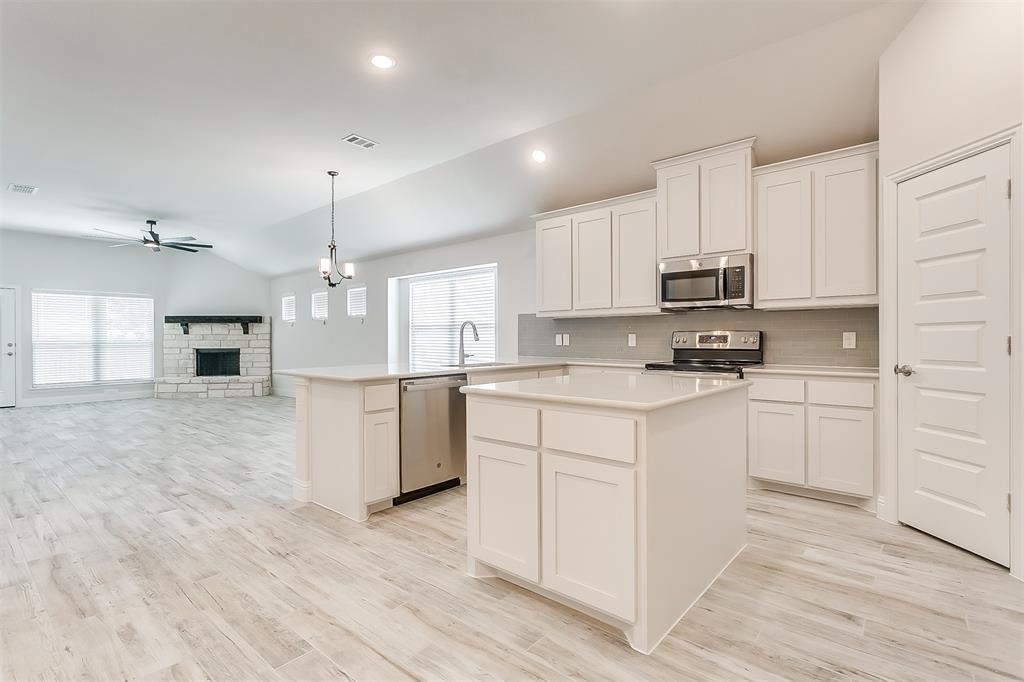 615 MB's Way Pilot Point, TX 76258 - Photo 1 of 1 a kitchen with kitchen island white cabinets and white appliances