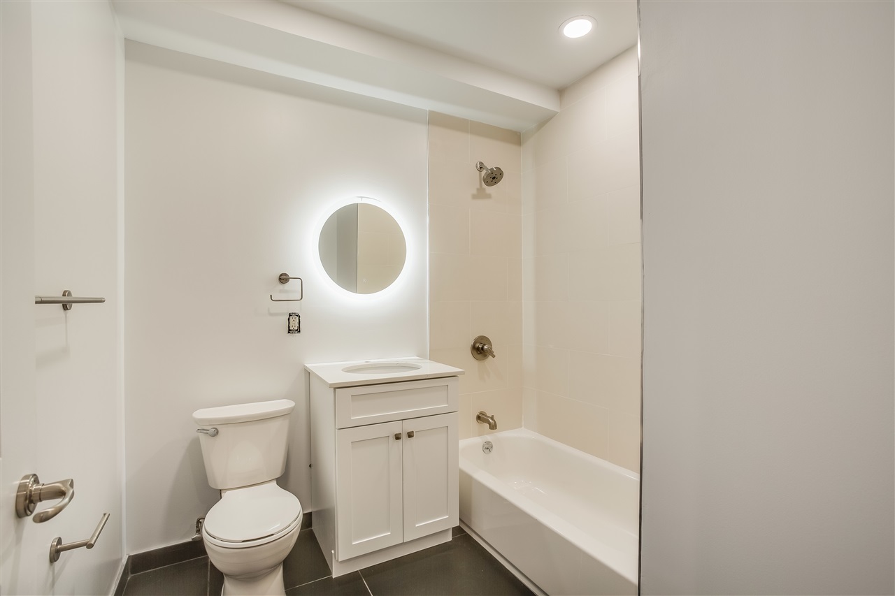 204 Grand Street, Unit 2C Hoboken, NJ 07030 - Photo 9 of 14 a bathroom with a toilet a sink and a bathtub