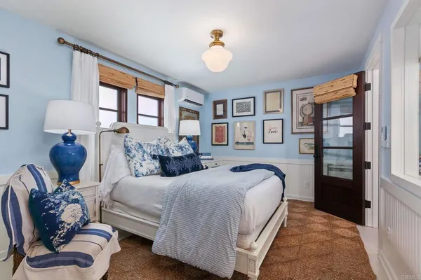 a bedroom with bed and wooden floor
