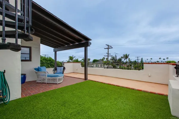 a view of a patio with dining table and chairs with a yard